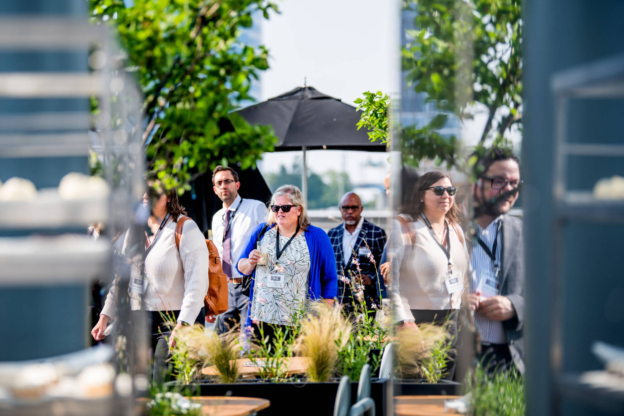 People mingle during the Black Boys and Men National Symposium VIP reception on the JW Marriott deck overlooking the Grand River June 11.